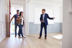 A realtor shows a couple the new house that they are purchasing