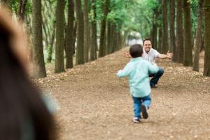 A boy running to his divorced father for a scheduled visitation