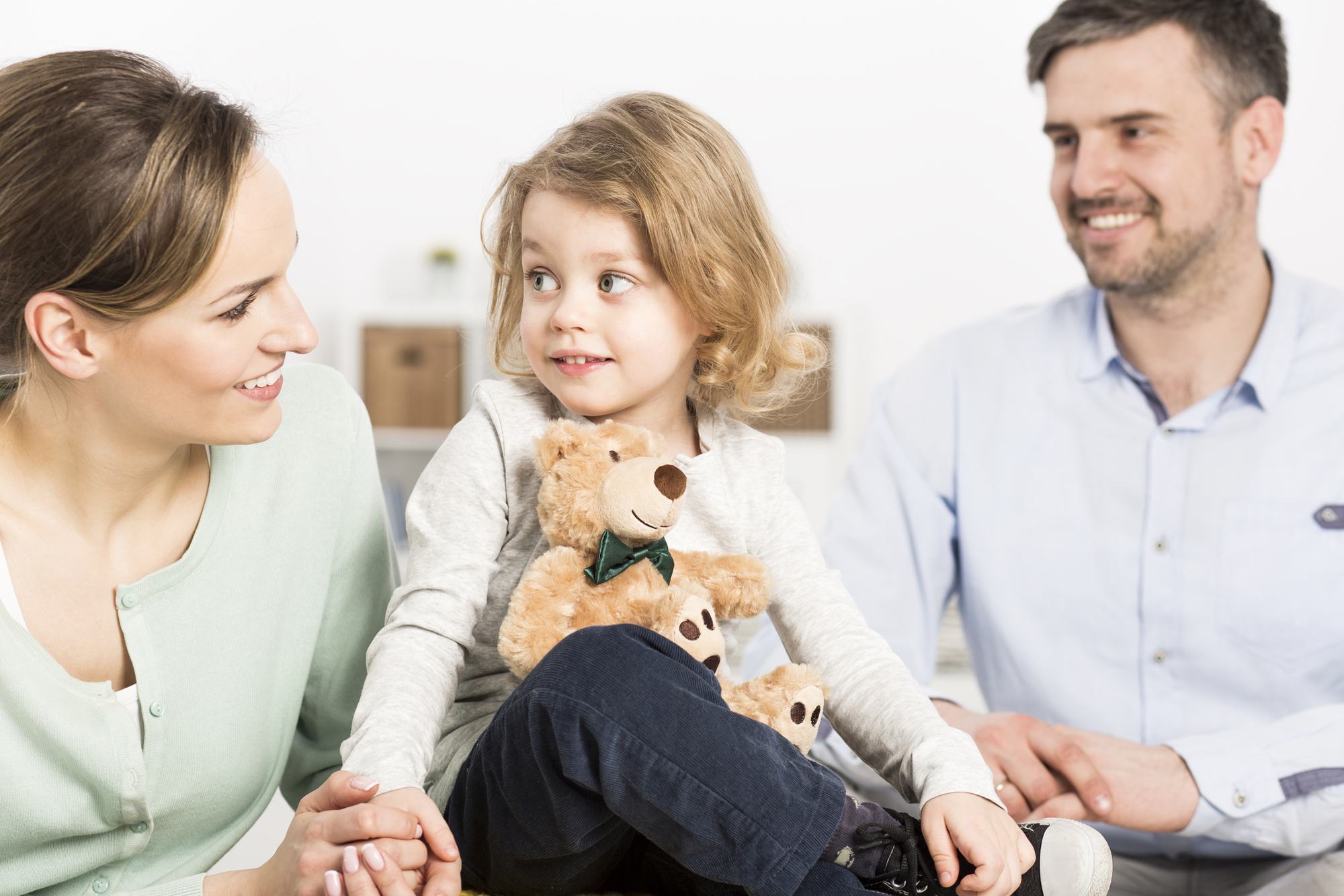 Child Sitting With Her Parents