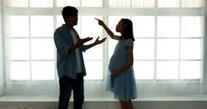 pregnant couple quarreling / getting a divorce