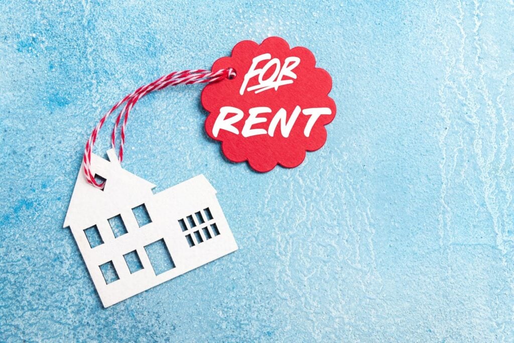 House for rent label on christmas holidays. Wooden house symbol with rent tag on blue background