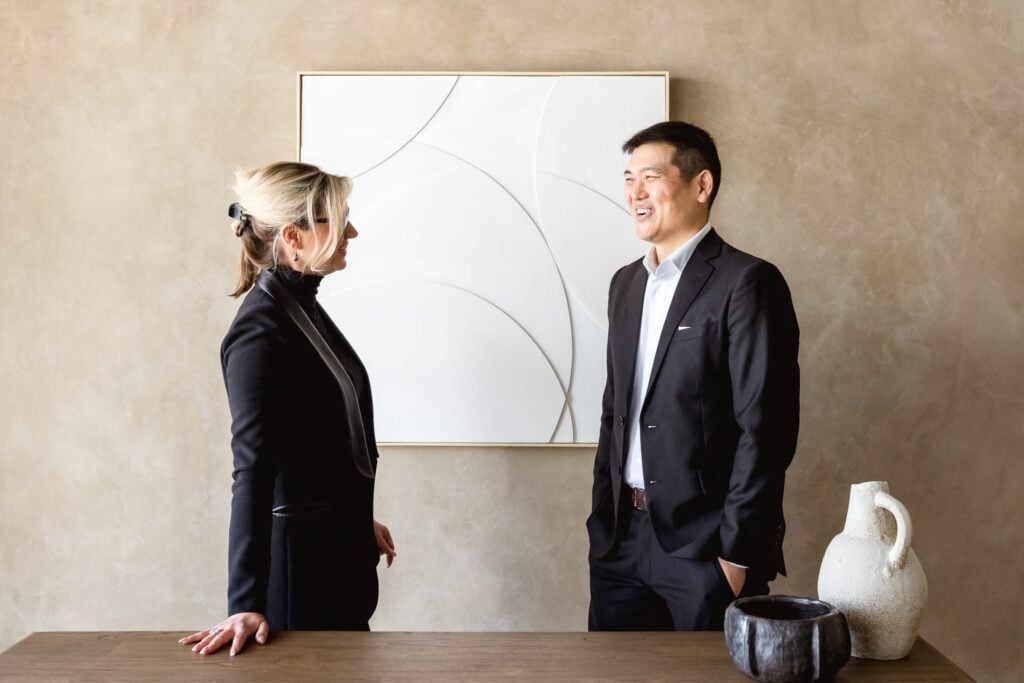 Two lawyers from Epstein & Associates having a chat in a modern office